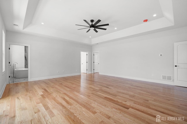 9 Links Dr, Edison, NJ 08820 - unfurnished living room featuring a tray ceiling, ceiling fan, light wood-style floors, and recessed lighting