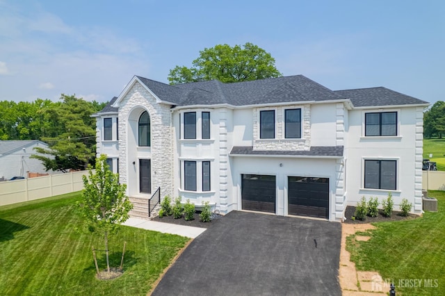 9 Links Dr, Edison, NJ 08820 - view of front of home with asphalt driveway, an attached garage, stucco siding, and a shingled roof