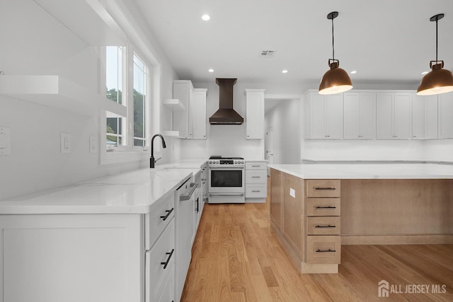 9 Links Dr, Edison, NJ 08820 - kitchen with stainless steel range oven, wall chimney range hood, light wood-type flooring, recessed lighting, and white cabinets
