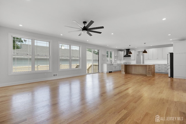 9 Links Dr, Edison, NJ 08820 - unfurnished living room with recessed lighting, plenty of natural light, ceiling fan, and light wood-style flooring
