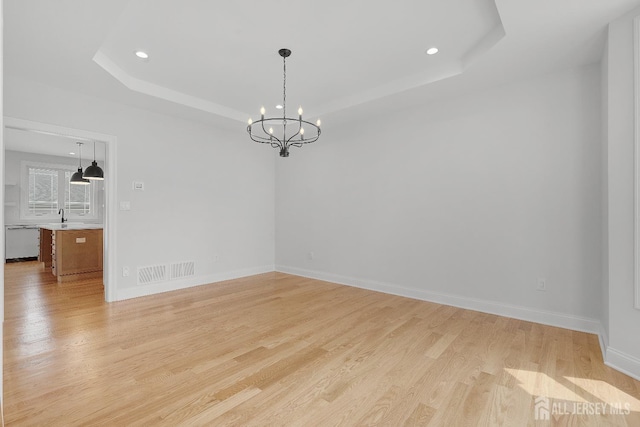 9 Links Dr, Edison, NJ 08820 - spare room with a raised ceiling, light wood-type flooring, a chandelier, and recessed lighting