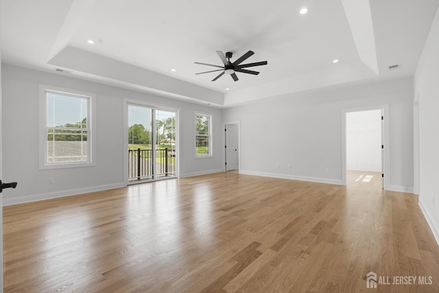 9 Links Dr, Edison, NJ 08820 - unfurnished living room featuring a raised ceiling, a ceiling fan, recessed lighting, and light wood-style flooring