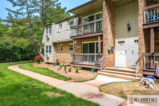 530 Andria Ave Unit 295, Hillsborough, NJ 08844 - doorway to property featuring a balcony, brick siding, a lawn, and board and batten siding