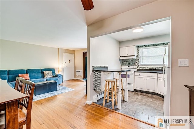 530 Andria Ave Unit 295, Hillsborough, NJ 08844 - kitchen with white range with electric cooktop, dark countertops, white cabinetry, tasteful backsplash, and open floor plan