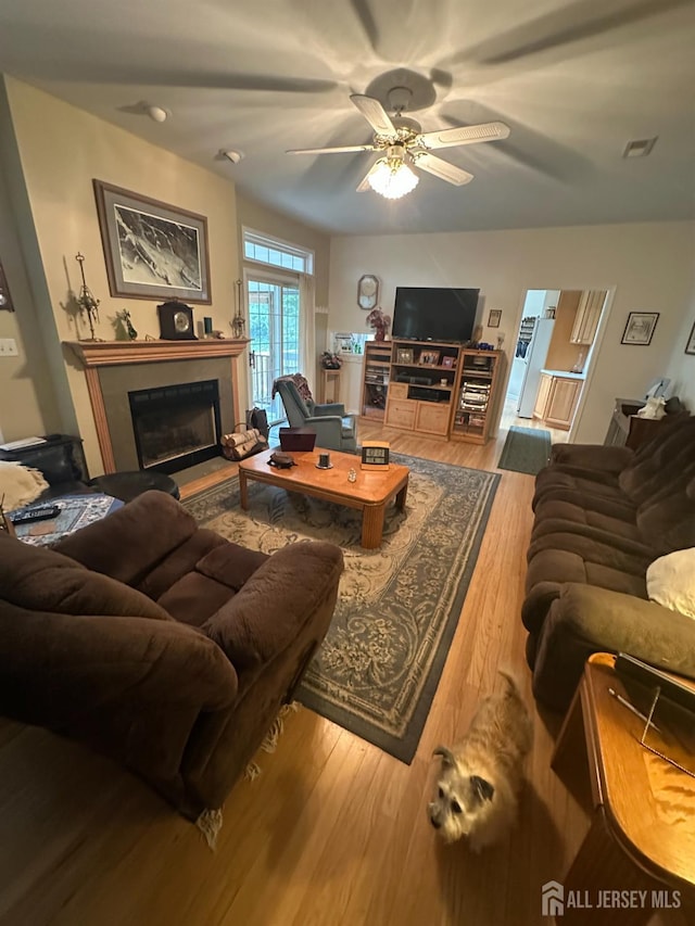 140 Bunker Hill Rd, Franklin Twsp, NJ 08540 - living room featuring a fireplace with raised hearth, wood finished floors, and ceiling fan