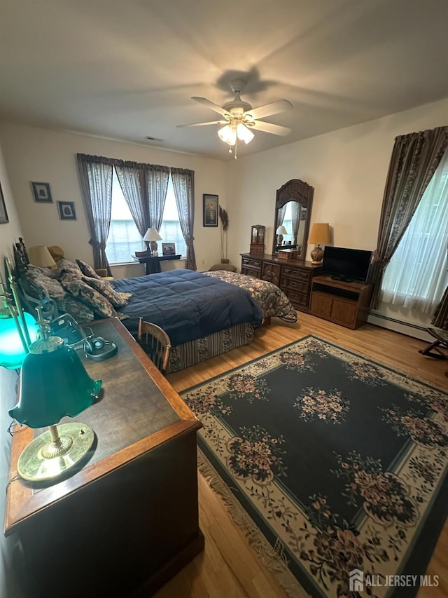 140 Bunker Hill Rd, Franklin Twsp, NJ 08540 - bedroom with wood finished floors, a baseboard radiator, and a ceiling fan