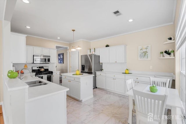 595 Waterside Blvd, Monroe, NJ 08831 - kitchen featuring white cabinets, a sink, marble finish floor, crown molding, and appliances with stainless steel finishes