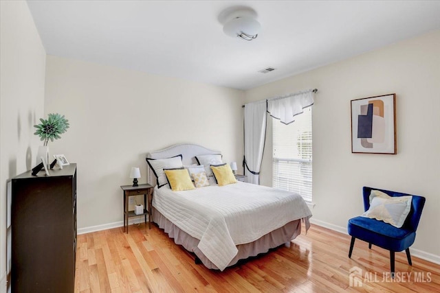 595 Waterside Blvd, Monroe, NJ 08831 - bedroom with visible vents, light wood-style flooring, and baseboards