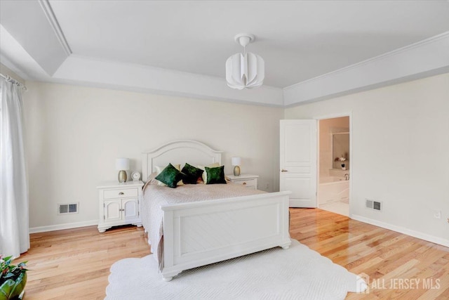595 Waterside Blvd, Monroe, NJ 08831 - bedroom featuring visible vents, a raised ceiling, and light wood-style floors