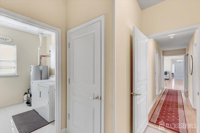595 Waterside Blvd, Monroe, NJ 08831 - hall with washing machine and clothes dryer, light wood-style flooring, and baseboards