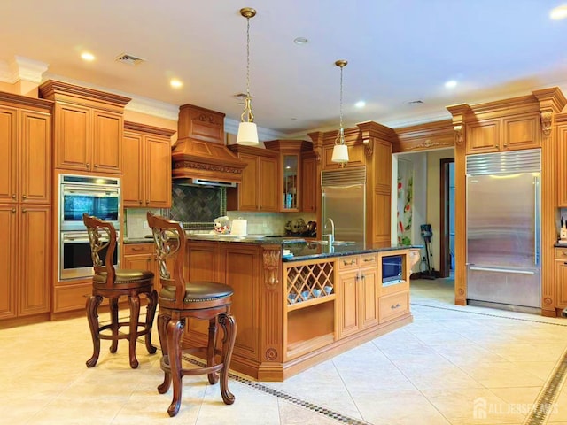 34 Line Rd, Holmdel, NJ 07733 - kitchen featuring stainless steel appliances, light tile patterned floors, a kitchen island with sink, crown molding, and recessed lighting
