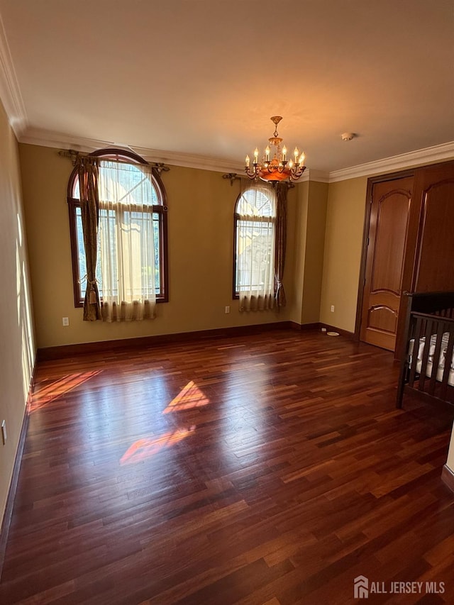 34 Line Rd, Holmdel, NJ 07733 - spare room with a chandelier, plenty of natural light, dark wood finished floors, and ornamental molding