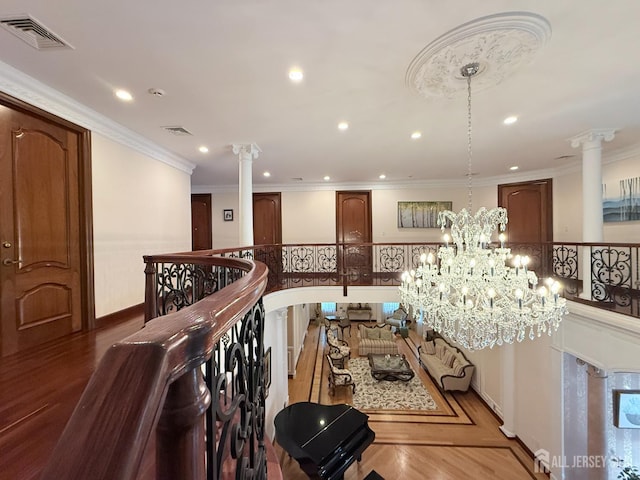 34 Line Rd, Holmdel, NJ 07733 - corridor with decorative columns, recessed lighting, a chandelier, crown molding, and an upstairs landing