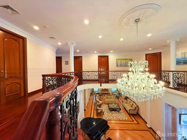34 Line Rd, Holmdel, NJ 07733 - corridor featuring decorative columns, recessed lighting, a chandelier, ornamental molding, and wood finished floors