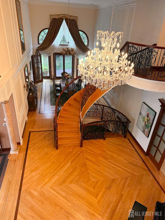 34 Line Rd, Holmdel, NJ 07733 - stairs featuring a chandelier, crown molding, and a towering ceiling