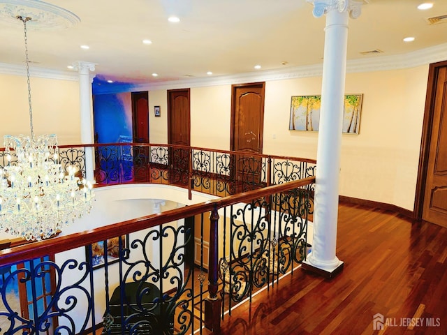34 Line Rd, Holmdel, NJ 07733 - hallway featuring crown molding, decorative columns, wood finished floors, recessed lighting, and a chandelier