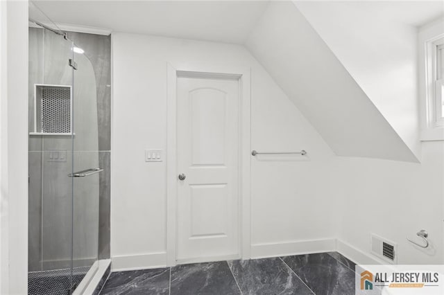 interior space with a stall shower, marble finish floor, visible vents, and baseboards