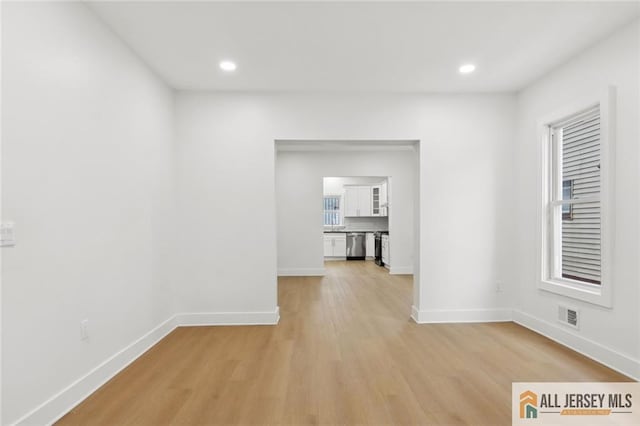 interior space with light wood-style floors, recessed lighting, visible vents, and baseboards