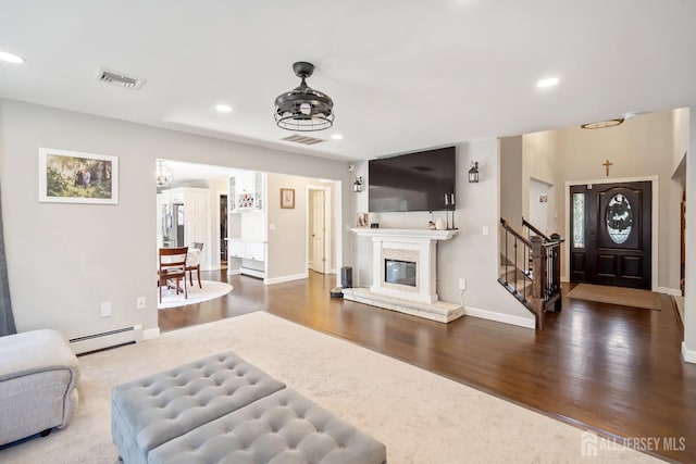 242 Green St, Old Bridge, NJ 08857 - living room with baseboard heating, wood finished floors, stairway, recessed lighting, and a glass covered fireplace