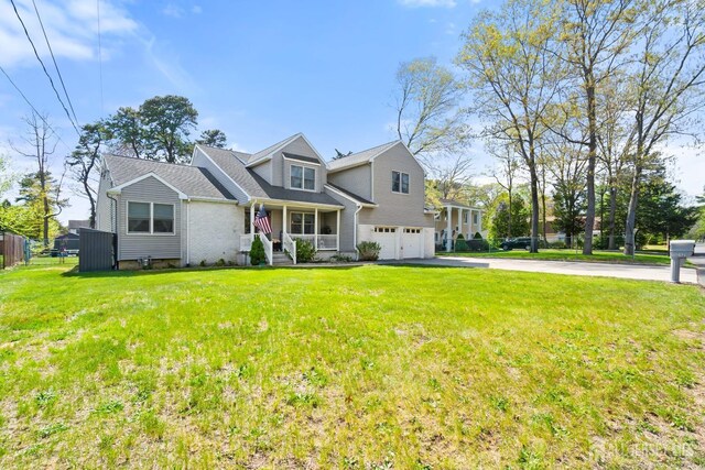 242 Green St, Old Bridge, NJ 08857 - view of front of home featuring a garage, asphalt driveway, and a porch