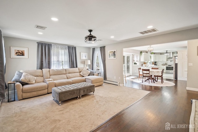 242 Green St, Old Bridge, NJ 08857 - living room with dark wood-type flooring, a baseboard radiator, recessed lighting, and a chandelier