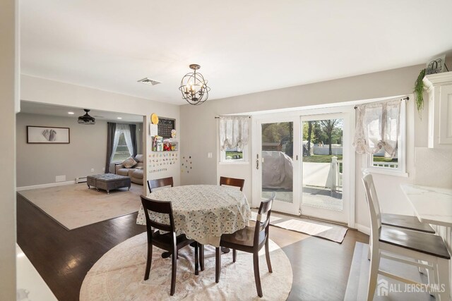242 Green St, Old Bridge, NJ 08857 - dining room featuring wood finished floors, a chandelier, and a baseboard radiator