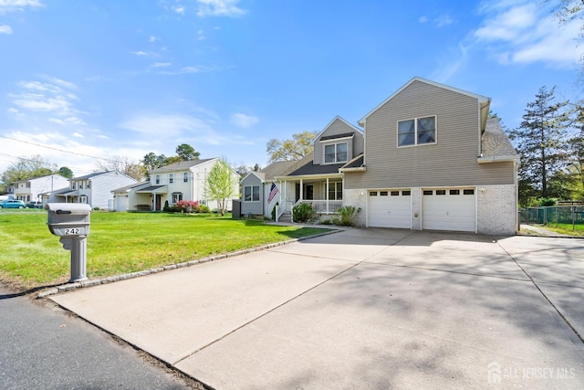 242 Green St, Old Bridge, NJ 08857 - traditional-style house featuring a residential view, an attached garage, driveway, and a front lawn