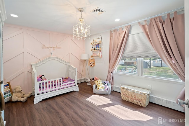 242 Green St, Old Bridge, NJ 08857 - bedroom with baseboard heating, a chandelier, a decorative wall, wood finished floors, and recessed lighting