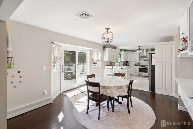 242 Green St, Old Bridge, NJ 08857 - dining area with dark wood-type flooring and a chandelier