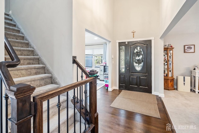 242 Green St, Old Bridge, NJ 08857 - entryway featuring stairway, a towering ceiling, and dark wood-style floors