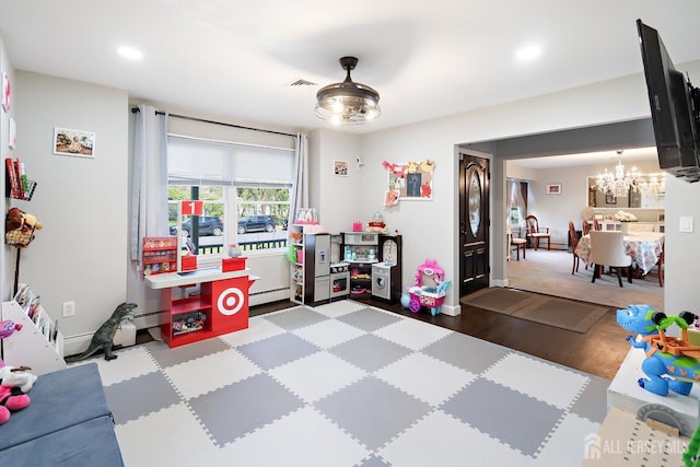 242 Green St, Old Bridge, NJ 08857 - recreation room featuring a chandelier, baseboard heating, recessed lighting, and wood finished floors