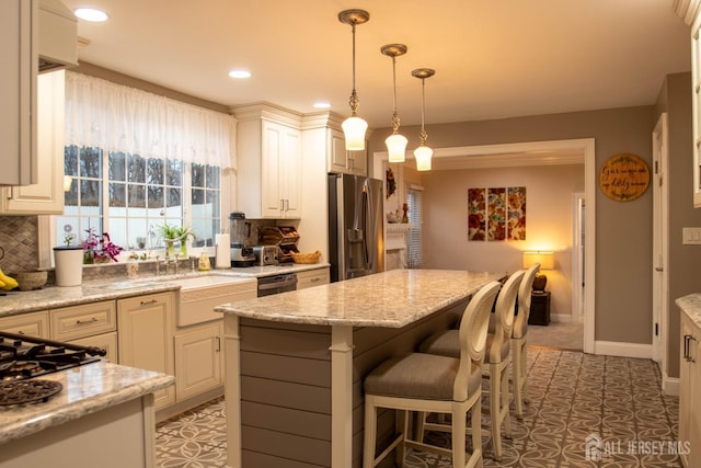 20 Wedgewood Ct, East Brunswick, NJ 08816 - kitchen featuring decorative light fixtures, light stone countertops, a kitchen island, and stainless steel refrigerator with ice dispenser