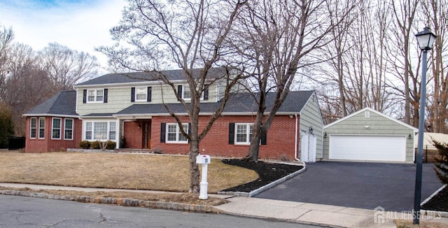 20 Wedgewood Ct, East Brunswick, NJ 08816 - traditional-style home with a front yard, an outdoor structure, brick siding, and a garage