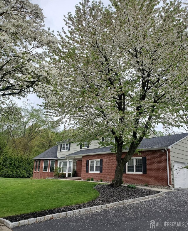 20 Wedgewood Ct, East Brunswick, NJ 08816 - view of front of home with a garage, a front lawn, and brick siding