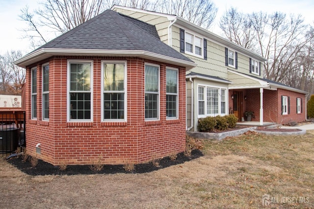20 Wedgewood Ct, East Brunswick, NJ 08816 - view of side of property with central air condition unit, a patio area, a shingled roof, and brick siding