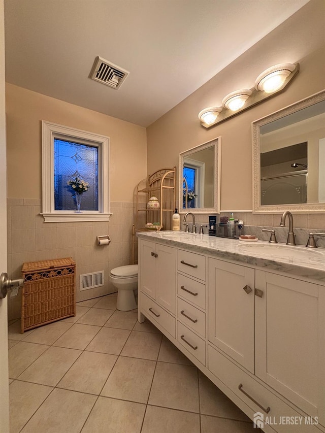 20 Wedgewood Ct, East Brunswick, NJ 08816 - bathroom with a sink, tile walls, visible vents, and tile patterned floors