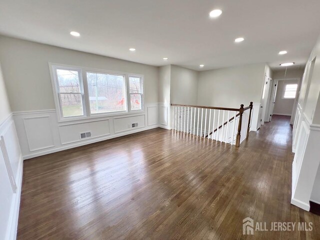 unfurnished room with dark hardwood / wood-style floors