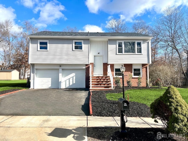 bi-level home featuring a garage and a front yard