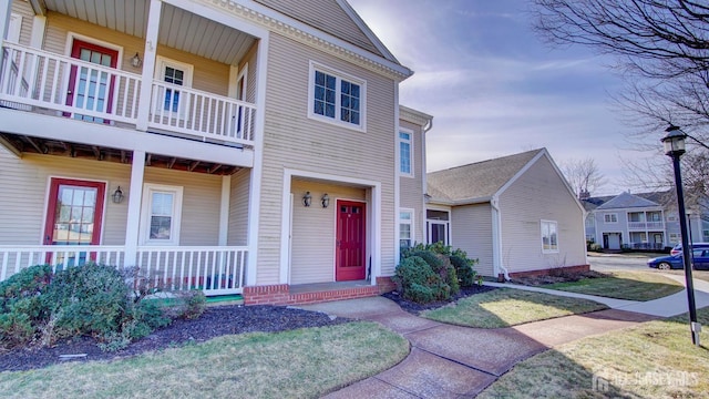 view of front of property with a balcony and covered porch