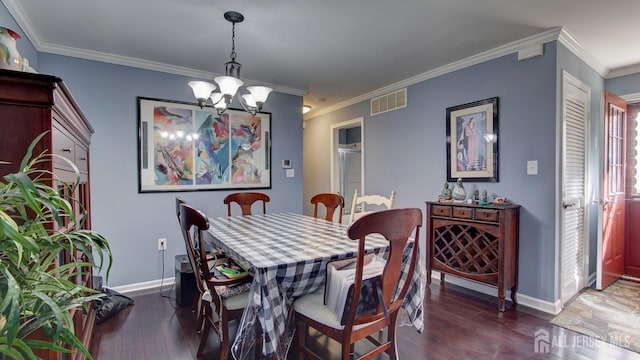 dining area with dark wood-type flooring, visible vents, baseboards, and an inviting chandelier