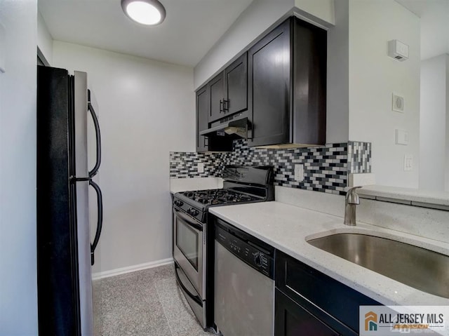 105 Longfield Ct Unit 105, East Brunswick, NJ 08816 - kitchen featuring appliances with stainless steel finishes, under cabinet range hood, backsplash, light stone countertops, and dark cabinetry