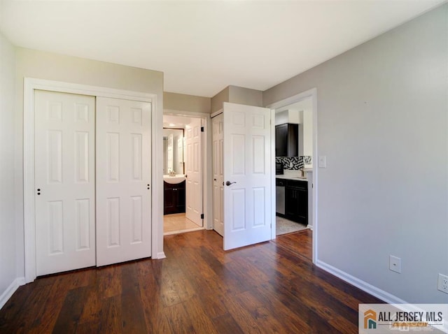 105 Longfield Ct Unit 105, East Brunswick, NJ 08816 - unfurnished bedroom with dark wood-style floors, ensuite bath, and multiple closets
