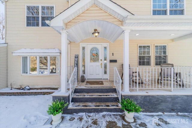 view of snow covered property entrance