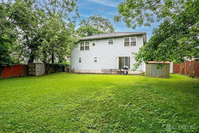 164 Mahar Ave, South Plainfield, NJ 07080 - back of house featuring a storage unit and a fenced backyard