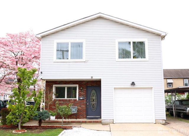 12 Yates Ave, South River, NJ 08882 - view of front of property featuring a garage, brick siding, and driveway