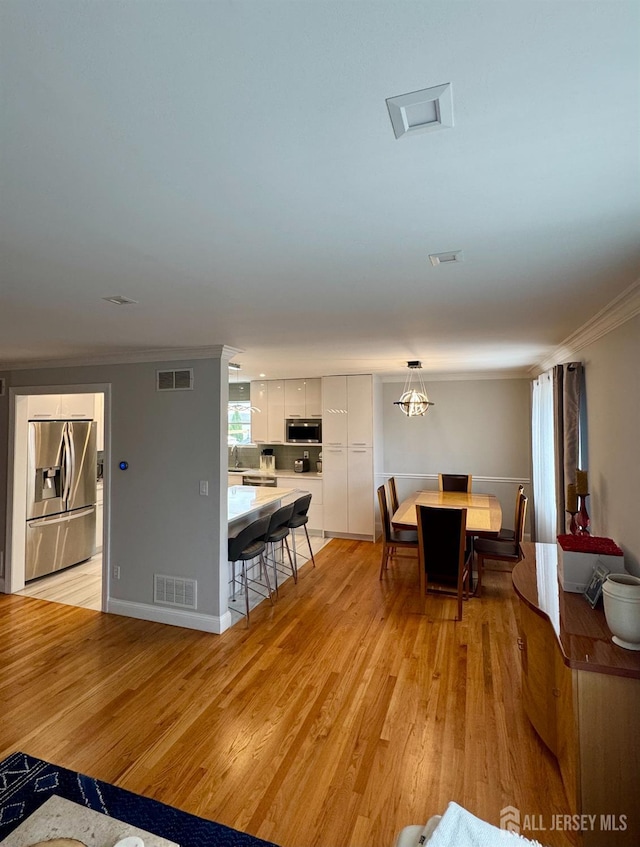 12 Yates Ave, South River, NJ 08882 - dining area with ornamental molding and light wood-style flooring