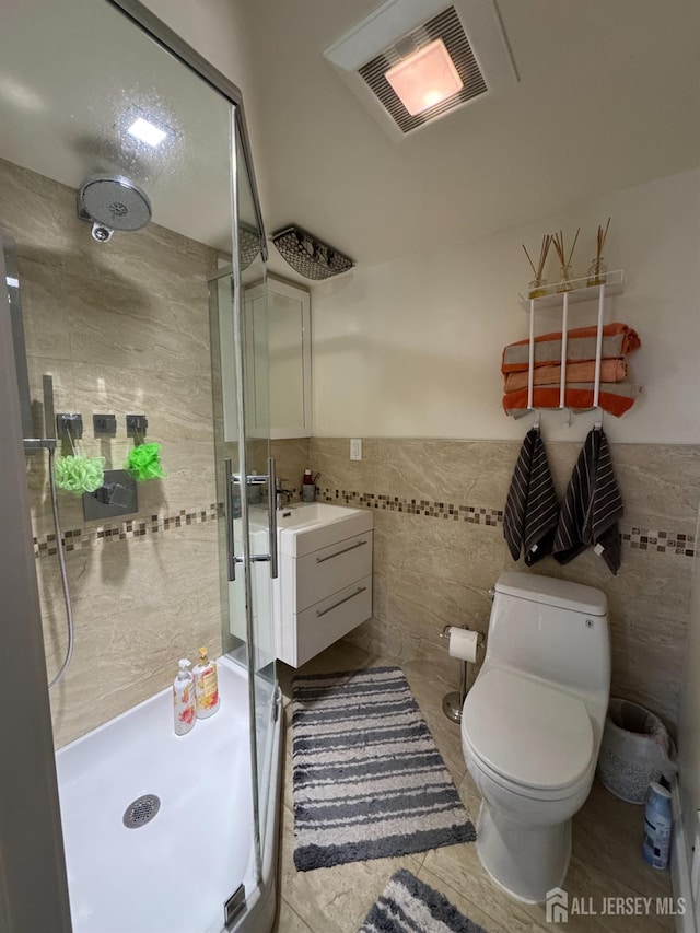 12 Yates Ave, South River, NJ 08882 - bathroom with tile walls, a shower stall, wainscoting, vanity, and tile patterned floors
