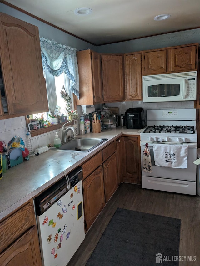 33 Cypress St, Carteret, NJ 07008 - kitchen with white appliances, light countertops, dark wood-style flooring, tasteful backsplash, and brown cabinetry