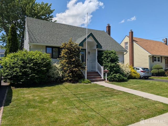 33 Cypress St, Carteret, NJ 07008 - view of front of home with roof with shingles and a front yard