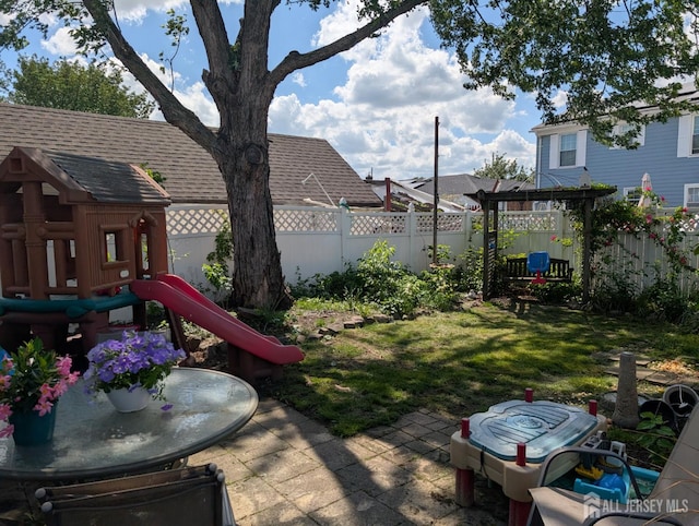 33 Cypress St, Carteret, NJ 07008 - fenced backyard with a playground